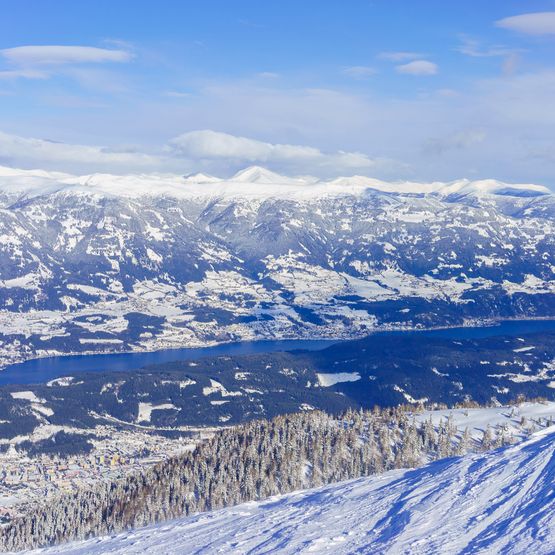 Blick auf verschneites Tal und See