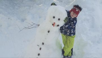 Kind mit Schneemann